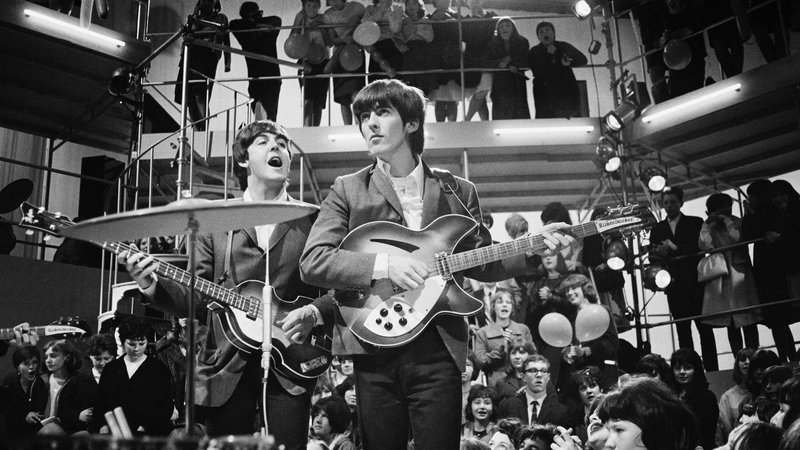 George Harrison (centre) with Paul McCartney