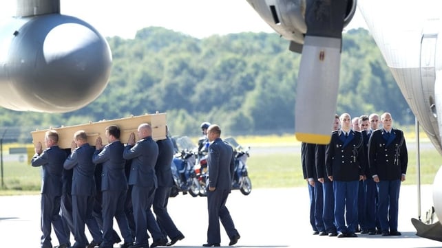 Dutch military personnel receive one of the coffins