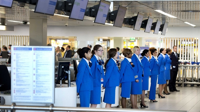 Stewardesses at Shiphol Airport observe a one-minute of silence in remembrance of the victims of the Malaysian Airlines MH17