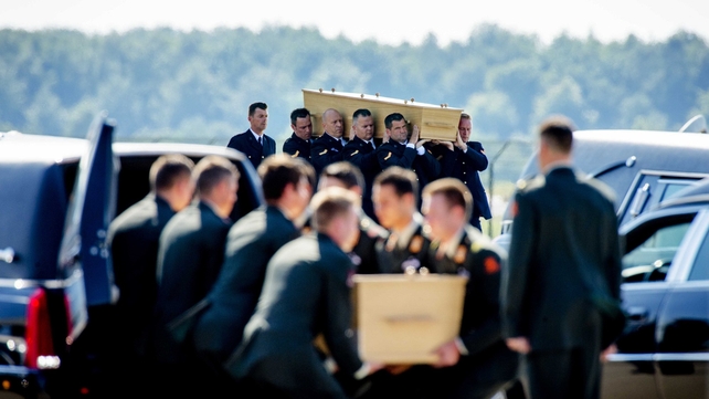 Soldiers and marines carried the coffins to 40 waiting hearses lined up on the runway