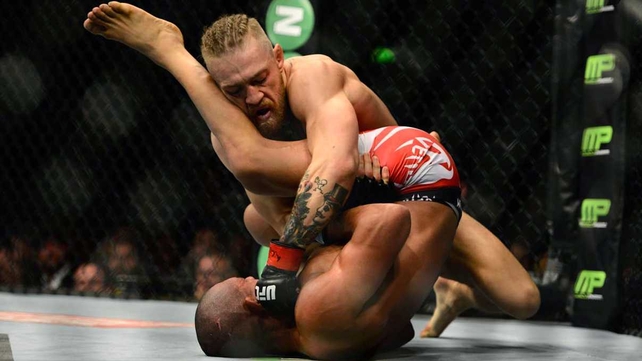 Conor McGregor with Diego Brandao of Brazil during the UFC fight night at the O2 on Saturday