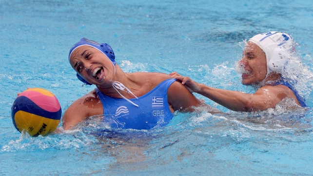 Italy's captain Tania di Mario (white) fights for the ball with Greece's Eleftheria Plevritou (blue) during the women's Water Polo European Championships match on Tuesday