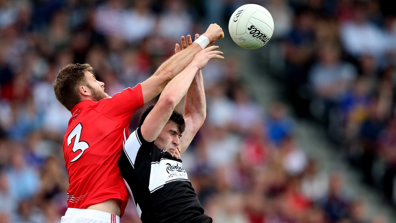Cork’s Eoin Cadogan and Pat Hughes of Sligo battle for the ball