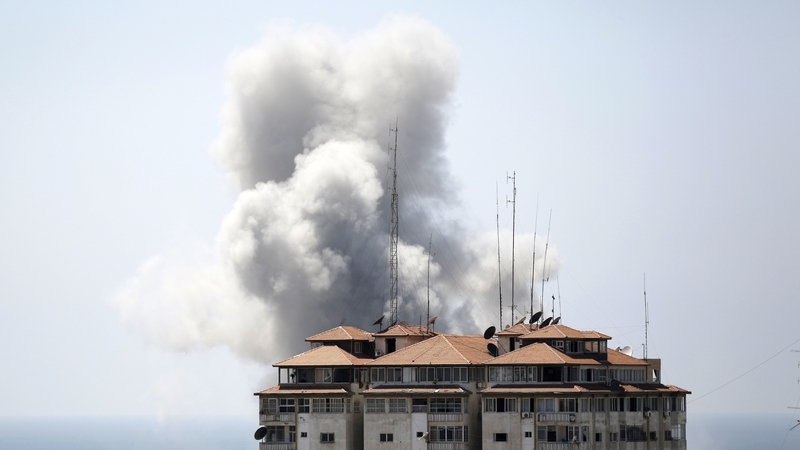 Smoke billows from a building hit by an Israeli air strike in Gaza City