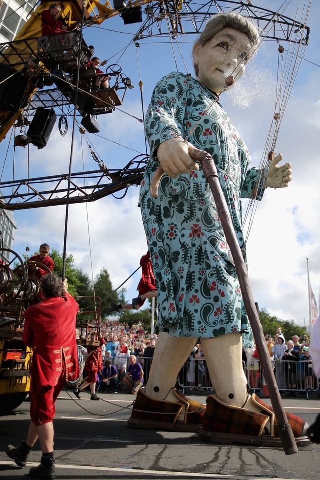 A giant puppet is led through the streets of Liverpool as part of World War I centenary festivities
