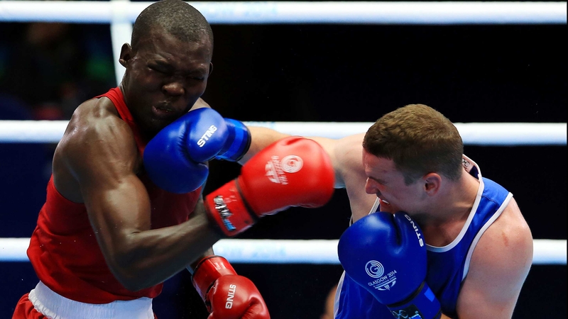 Elly Ajowi Ochola winces as Sean McGlinchy connects with a stinging right hook in their light heavyweight bout