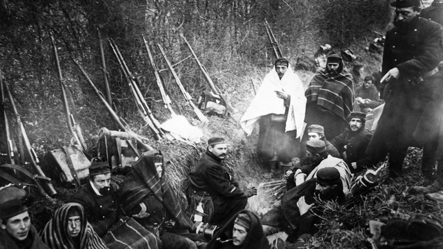 Belgian soldiers try to keep warm in the trenches on the Western Front
