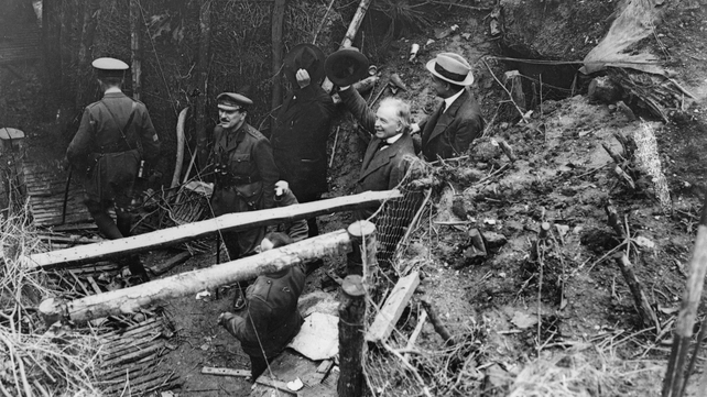 British Prime Minister David Lloyd George acknowledges cheers from British troops as he emerges from a captured German dug-out at Fricourt