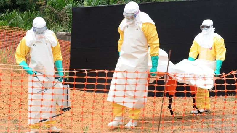 Doctors remove the body of a person killed by viral haemorrhagic fever in Guinea