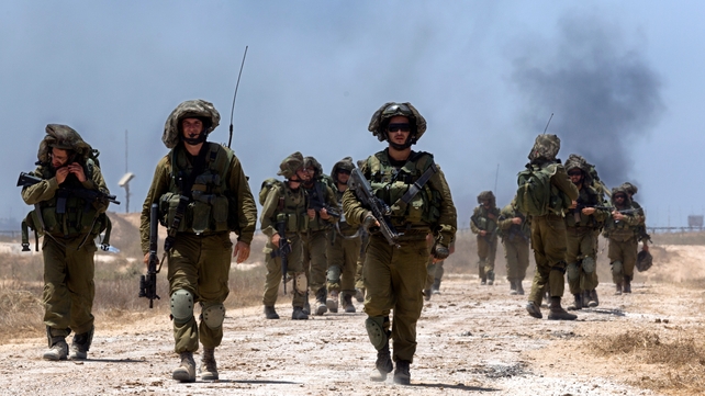 Israeli infantry troops walk into southern Israel after fighting inside Gaza
