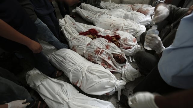 The bodies of those killed in the air strike are lined up at the same hospital