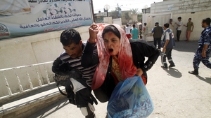 A wounded Palestinian woman arrives at al-Najar hospital in the south of Gaza this morning