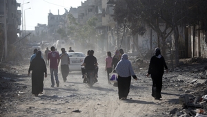 Palestinians who were displaced returning to check their homes in Gaza City's Shejaiya neighbourhood