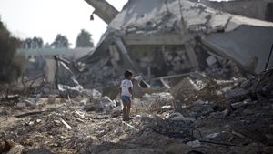 A boy stands alone in the rubble of his neighbourhood in Gaza City