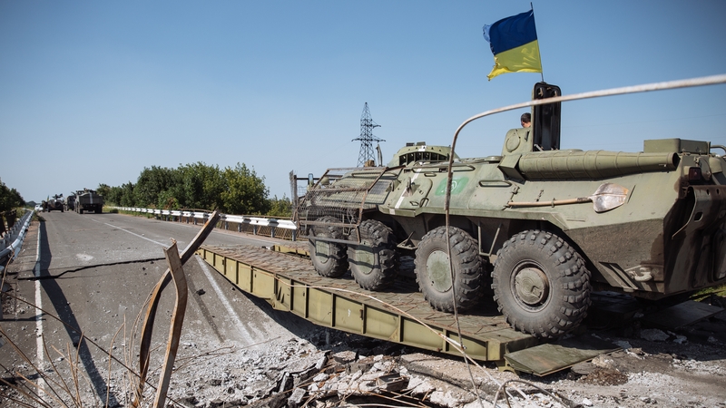 A Ukrainian Armoured Personnel Carrier (APC) crosses a destroyed bridge near Debalcevo