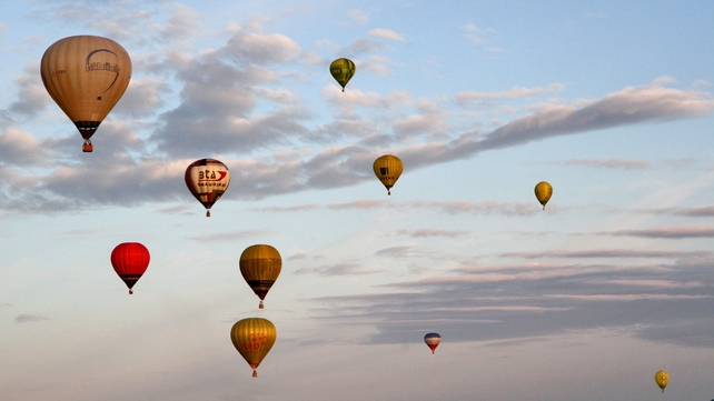 Hotair balloons fly over a field near Klaipeda, Lithuania