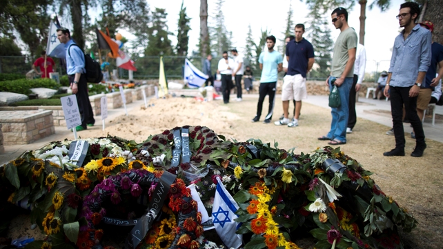 Wreaths on the grave of an Israeli soldier killed in the fighting as people pay tribute at the military cemetery on Mount Herzl, Jerusalem