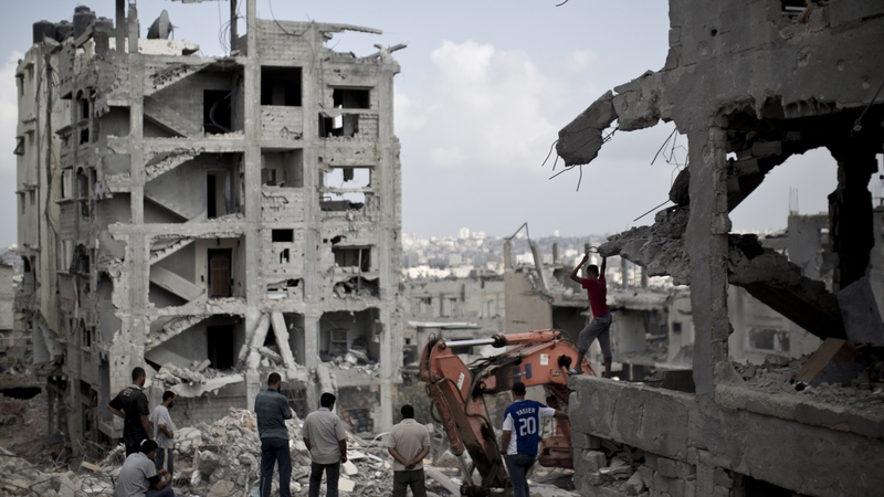 Palestinian men inspect the destruction in part of Gaza City's al-Tufah neighbourhood