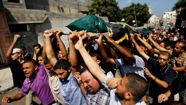 Mourners carry the body of the Al-Quds brigade’s field commander Sha-aban Al-Dahdoh during his funeral in Gaza City