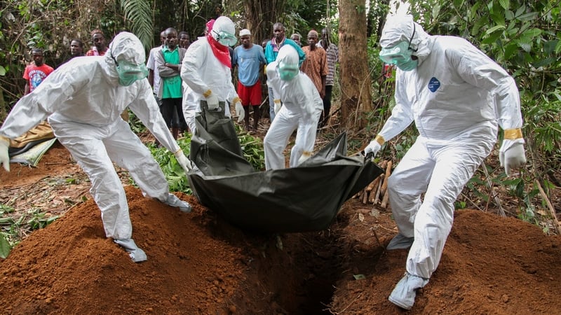 Liberian nurses bury the body of an Ebola victim on the outskirts of Monrovia in Liberia