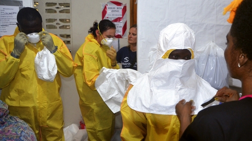 staff of the Christian charity Samaritan's Purse put on protective gear in the ELWA hospital in the Liberian capital Monrovia