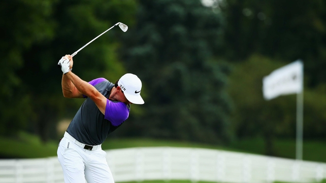 On the range: McIlroy warms up before the final round - he carded two bogeys early on to give others a shot at glory
