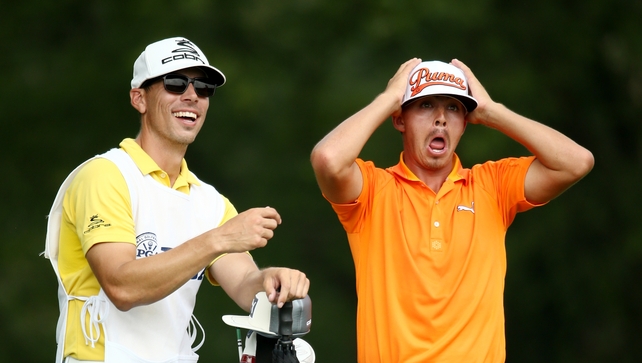 Ricky Fowler reacts to this shot on the fifth - a hole he birdied - as caddie Joe Skovron sees the funny side. Fowler and Mickelson held the lead round the turn.