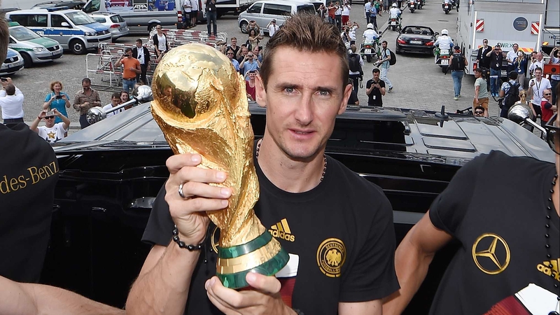 Miroslav Klose poses with the World Cup