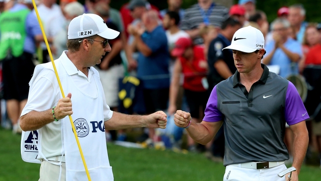 Caddie JP Fitzgerald and McIlroy after McIlroy had rolled in the putt from seven feet to claim the eagle that put him back in control of the championship