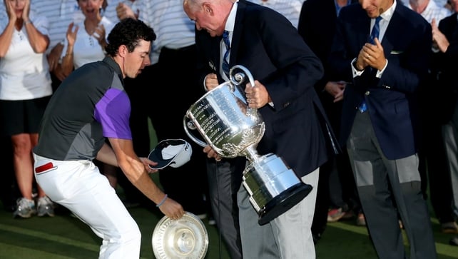 Still sharp, McIlroy saves the top part of the massive Wannamaker Trophy from hitting the turf during the presentation
