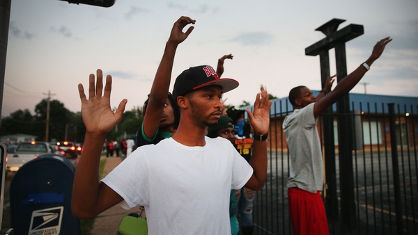 Protesters are forced by police from the business district into nearby neighbourhoods in Ferguson