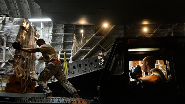 US soldiers prepare pallets of humanitarian aid for an airdrop over Iraq