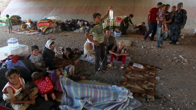 Iraqi Yazidis gather at a makeshift shelter in Dohuk