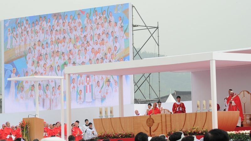 Pope Francis leads the beatification ceremony of 124 Korean martyrs (depicted on screen during the mass