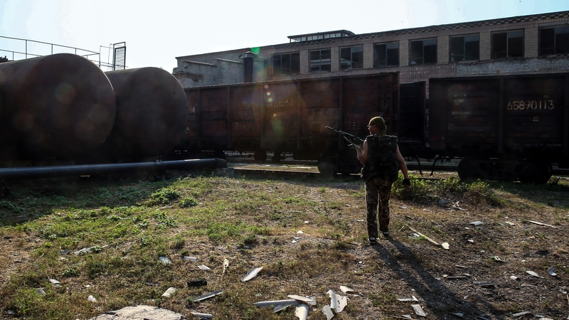 A militia member checks damage after an apparent shelling by the Ukrainian army near Donetsk