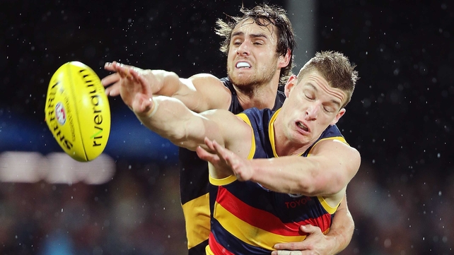 Ben Griffiths of the Richmond Tigers competes with Josh Jenkins of the Adelaide Crows in their AFL encounter