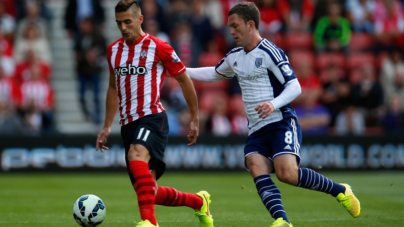 Dusan Tadic of Southampton is marshalled by Craig Gardner of West Brom