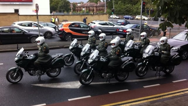 Army outriders wait to accompany the funeral cortege