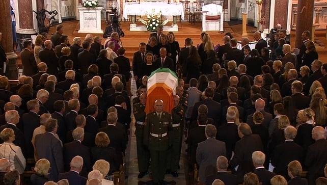 The coffin carrying Mr Reynolds's remains is carried from the church