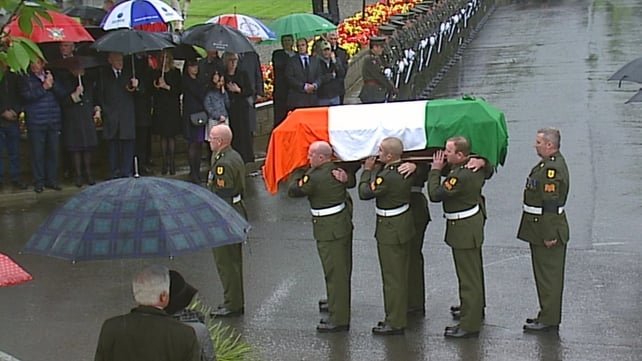 Mr Reynolds's coffin is carried by members of the Defence Forces