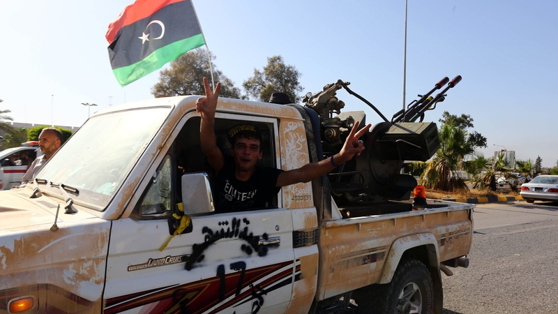 An Islamist fighter flashes the V sign for victory at the entrance of Tripoli international airport