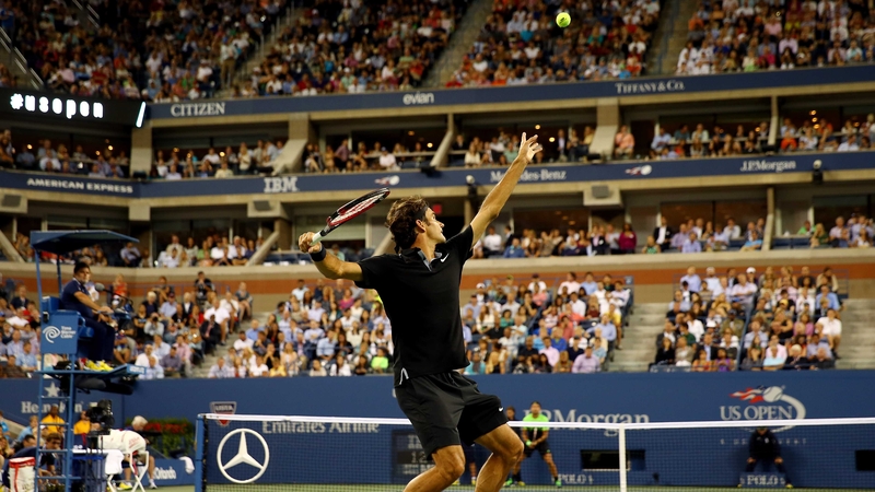 Roger Federer of Switzerland serves against Marinko Matosevic
