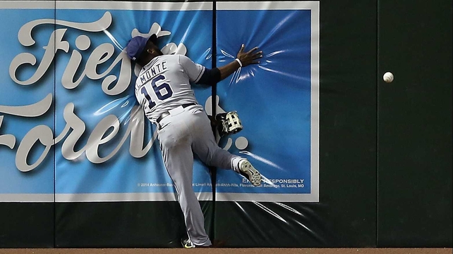 Abraham Almonte of the San Diego Padres crashes into the wall during the MLB game at Chase Field in Phoenix, Arizona