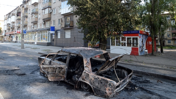 Shelling in Donetsk brought down a tram cable, sitting this car alight and killing three people
