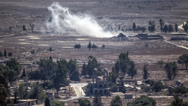 Smoke rises from the Syrian village of Quneitra, as seen from the Israeli-occupied Golan Heights