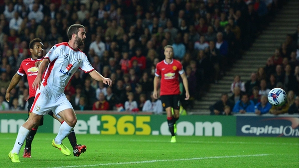 Will Grigg scores against United