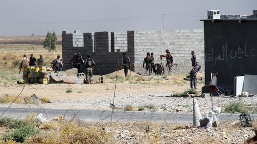 Iraqi and Turkmen fighters hold a position in the beseiged town of Amerli earlier this month
