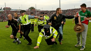 Break for the border - Referee Cormac Reilly makes a quick exit at the end of the Kerry-Mayo replay
