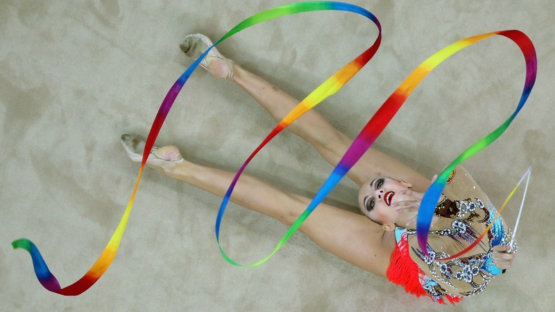 A competitor in the rhythmic gymnastics swirls at the Youth Olympic Games in China
