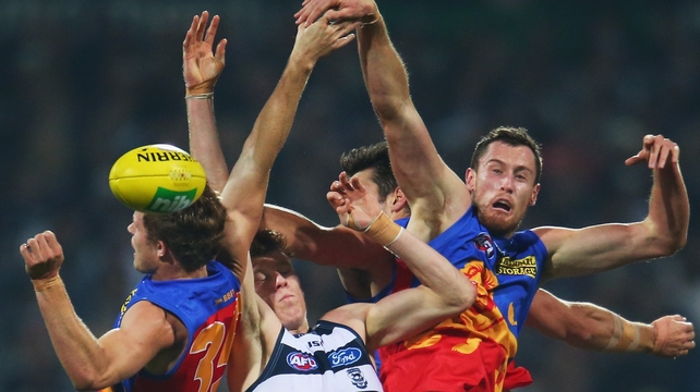 Geelong Cats and Brisbane Lions battle for the ball during their AFL tie in Simonds Stadium, Geelong